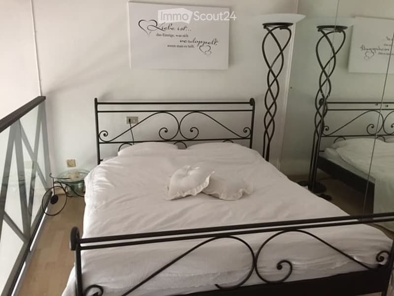 two beds, white bedding, iron headboards, bedside lamps, glass table, glass balustrade