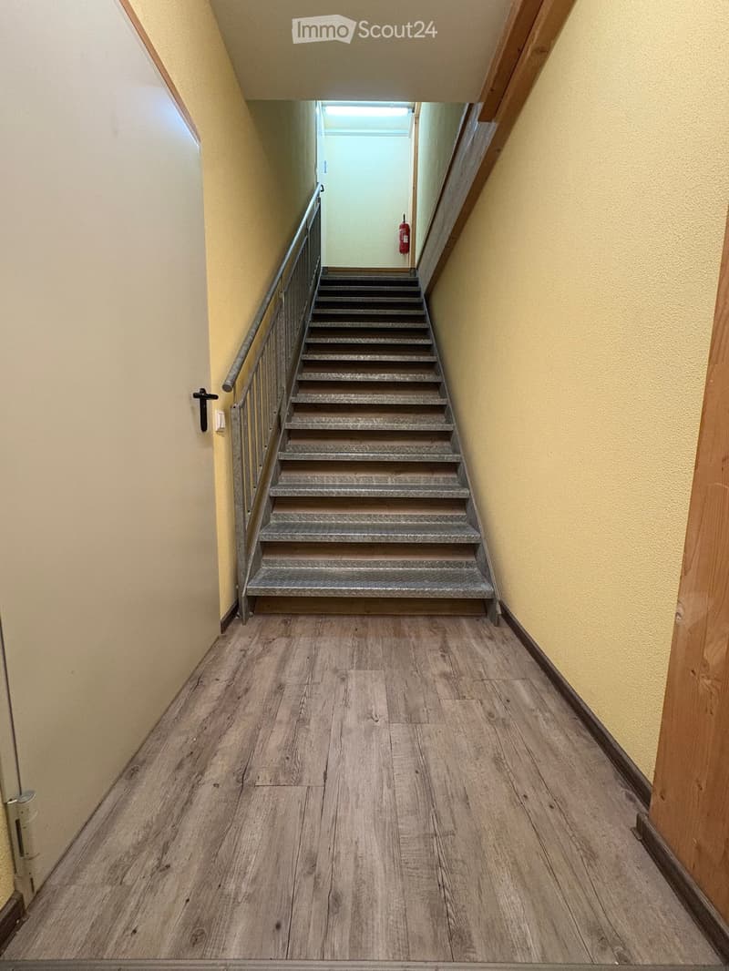 steel steps, grey wooden flooring, yellow walls, fire extinguisher