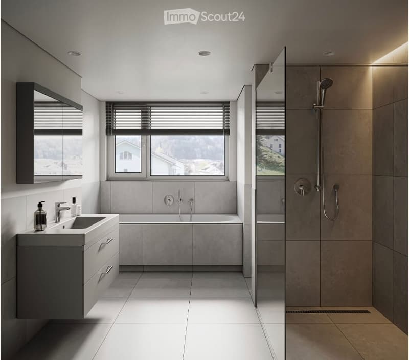Large bathroom with modern, minimalist design. Features a bathtub, vanity with sink, and a walk-in shower with a rainfall showerhead. The room has large windows providing natural light and a view of the outdoors.