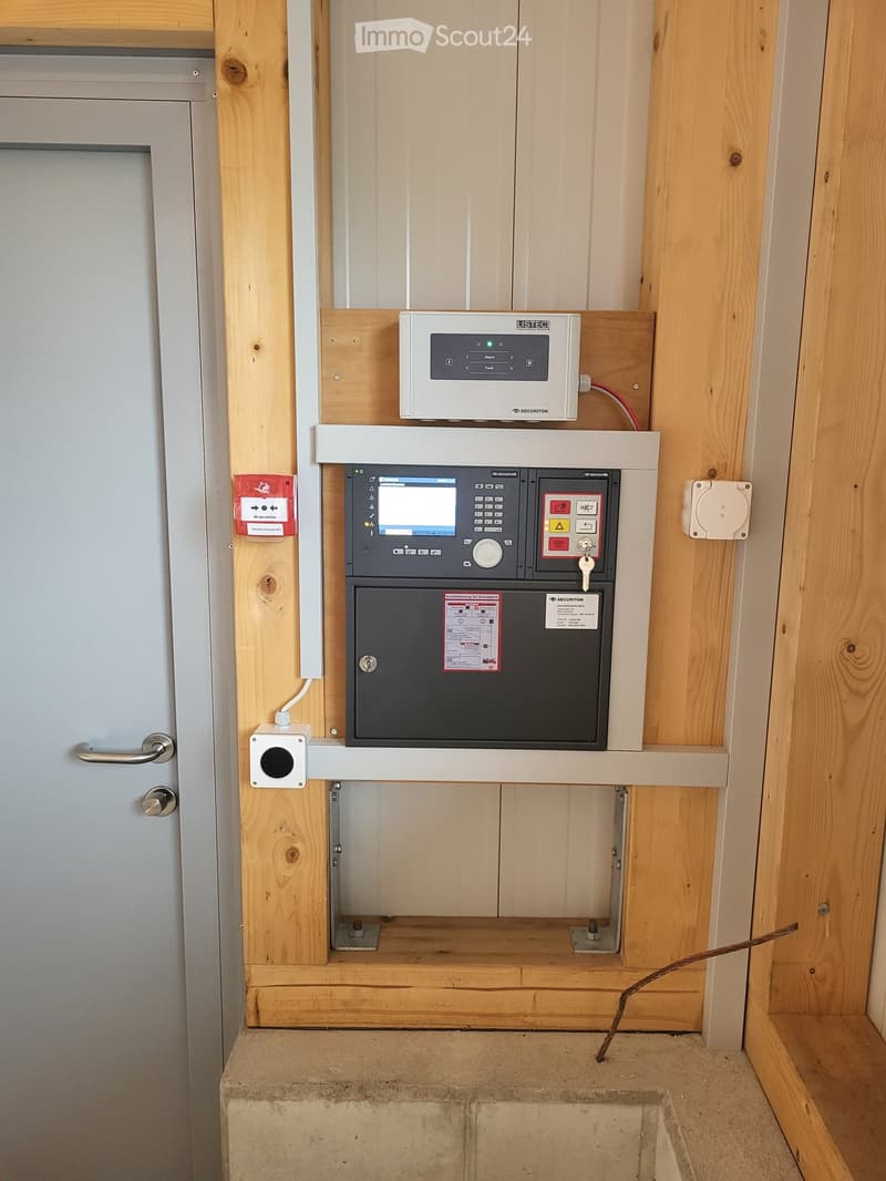 Electrical system with meter, control panel and various components attached to wooden wall