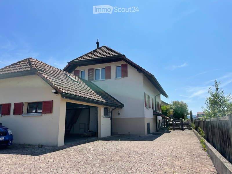 white two story house, brown tiled roof, blue car parked, garage