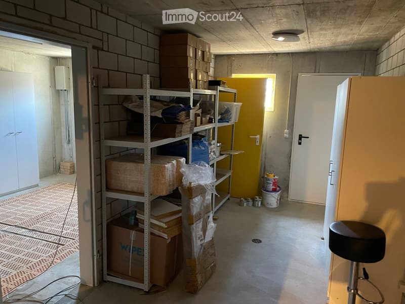 storage room with shelves and various items like boxes, buckets, plastic bags, buckets with paint