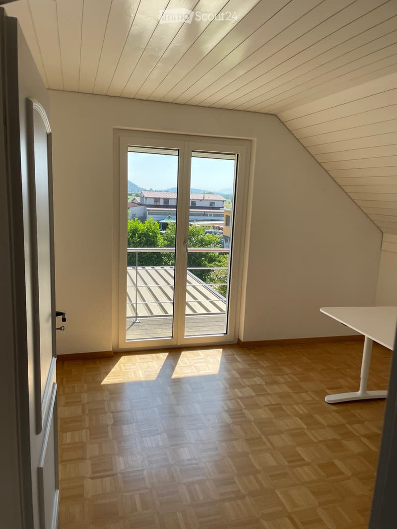 Balcony, sliding glass doors, wooden floor, white table, white walls