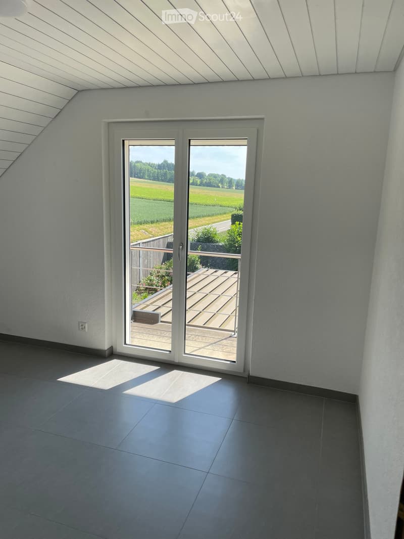 sliding glass doors to balcony, gray tiles, white walls, power outlet