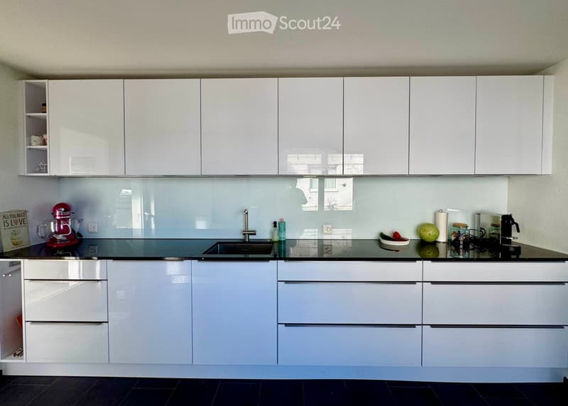 modern white kitchen, black marble countertop, integrated appliances, modern cabinets