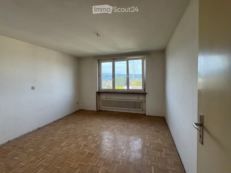 empty room, white walls, parquet floor, white radiator, window