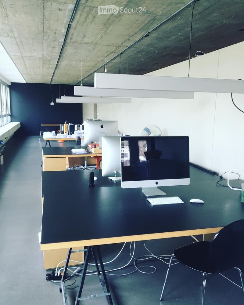 office room with desks, monitors, and other office equipment