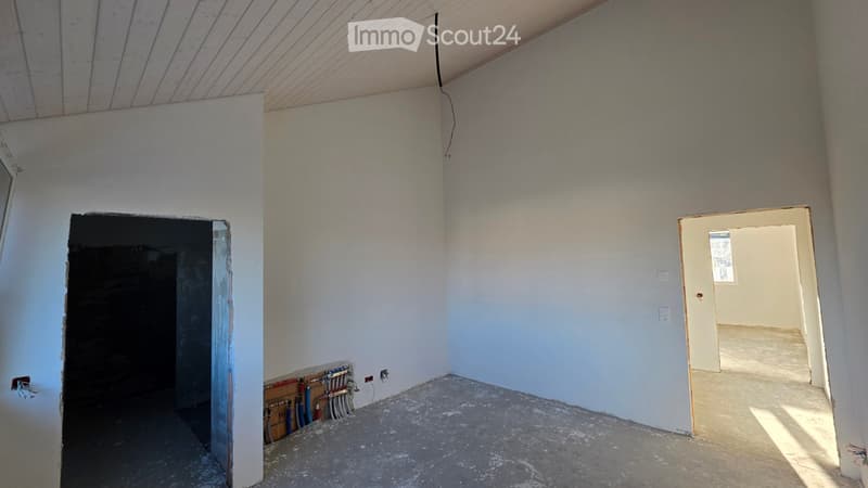 empty room, white walls, concrete floor, electrical outlets, pipes