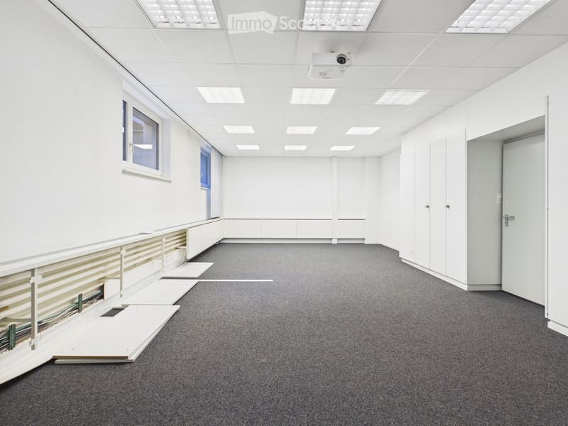 empty room, white walls, gray carpet, white ceiling, window, white cabinets, surveillance camera