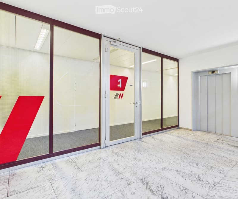 Marble floor, glass doors, elevator, red sign with number 1
