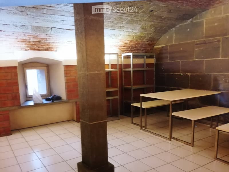 Empty room, brick walls, tiled floor, shelves, window seat, desks