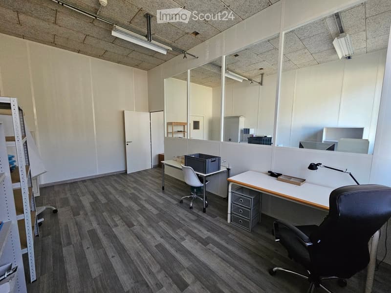 empty room with white walls, wooden floors, office furniture, and mirrors