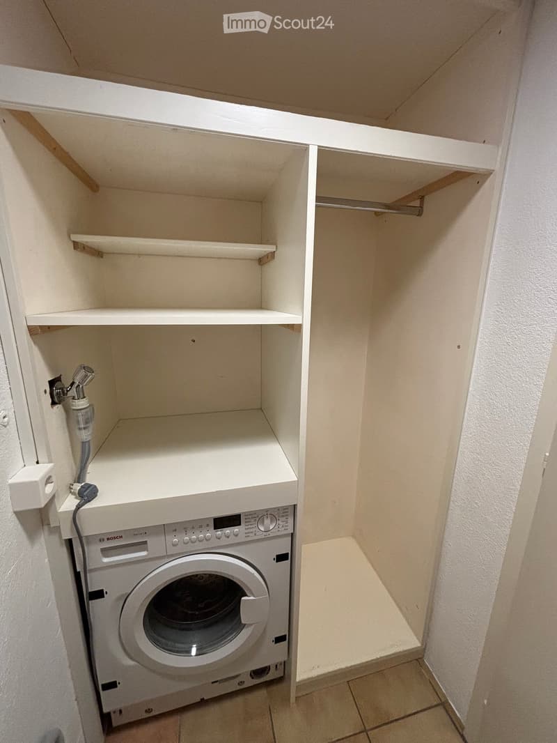 white cabinets, washing machine, floor drain
