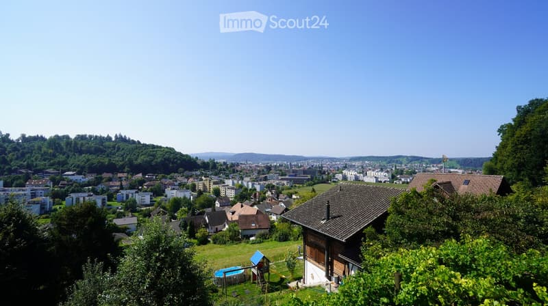 House with a view of a town in the background