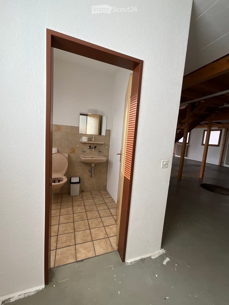 empty bathroom, tile flooring, toilet, sink, mirror, trash bin, open door