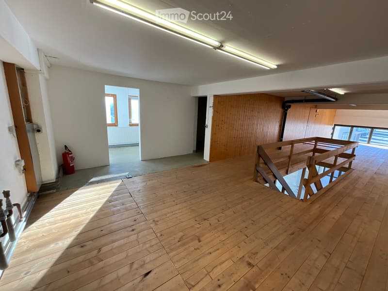empty room with wooden floor, 2 doors, stairs, fire extinguisher