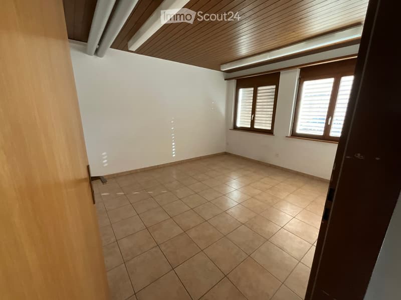 empty room, wooden door, tiled floor, wooden ceiling, white walls, two windows