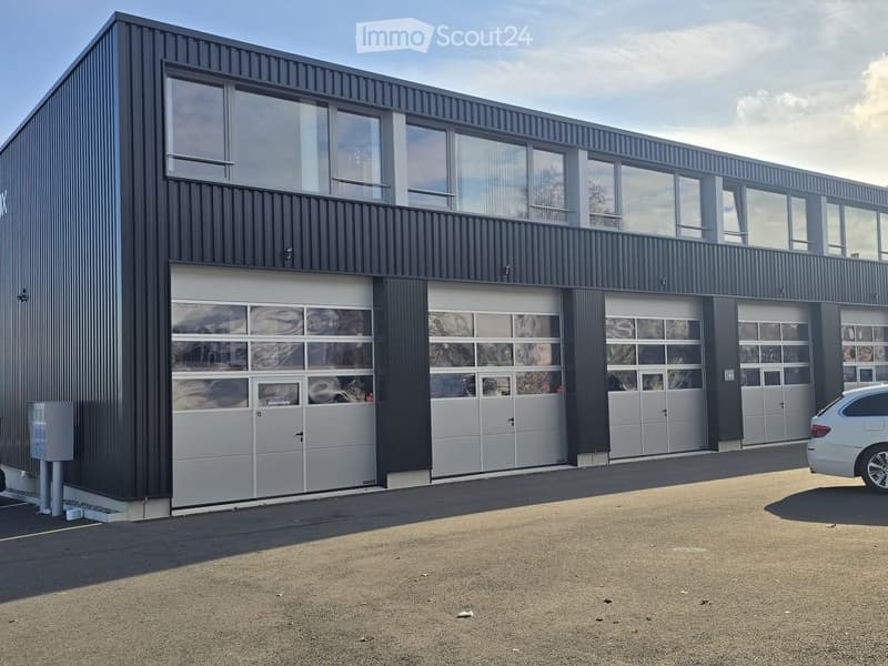 Modern building, large garage doors, large windows, flat roof