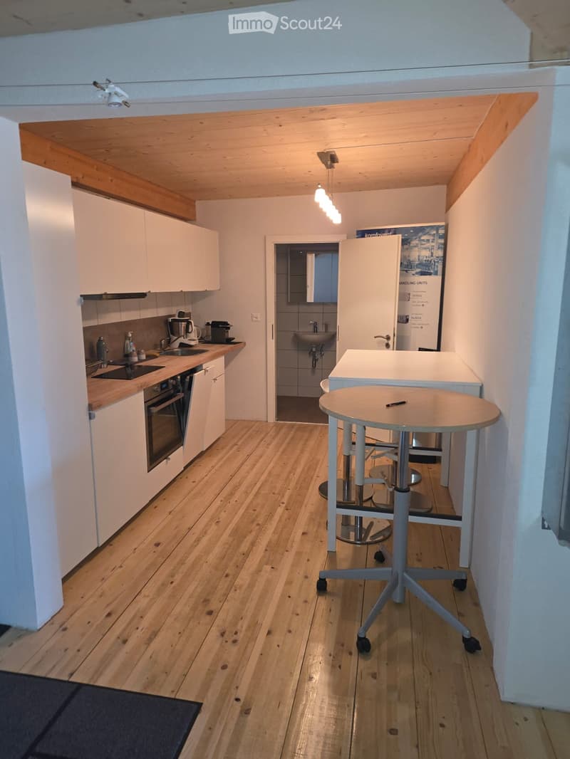 fully equipped kitchen with white cabinets, countertop, modern appliances, tiled floor