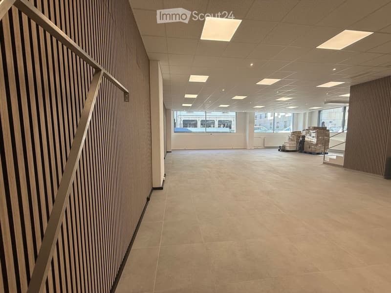 empty room, tiled floor, white ceiling, large windows, brown wall panels