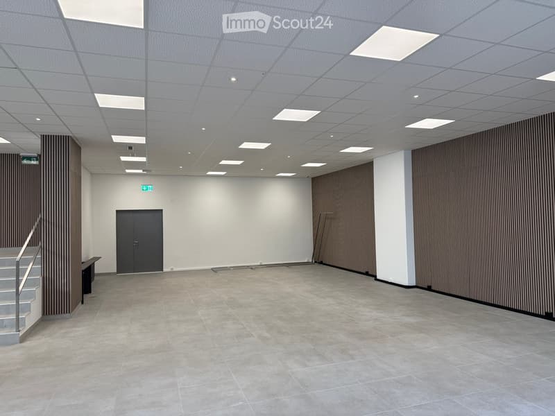 empty room, tiled floor, white walls, gray door, brown wall panels, metal handrail, metal stand
