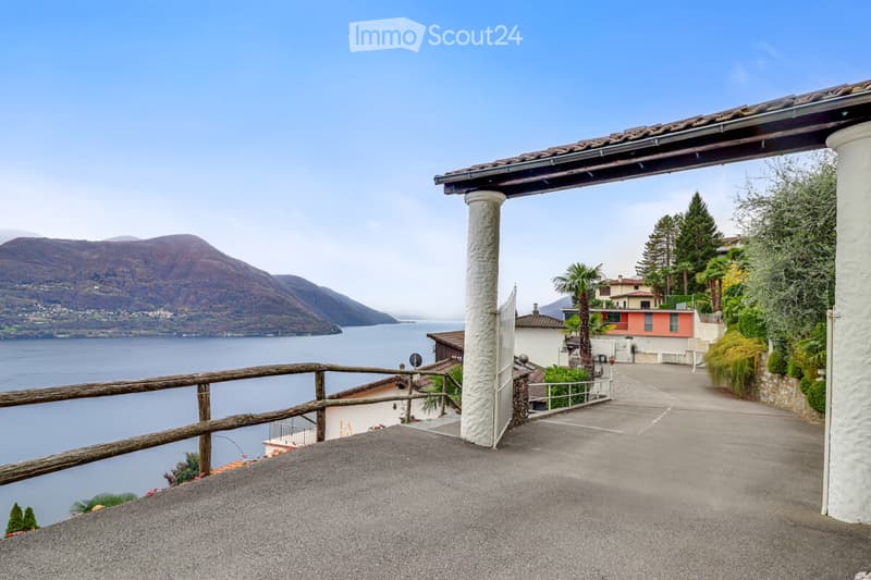 View from roof with balcony and mountains and lake in the background