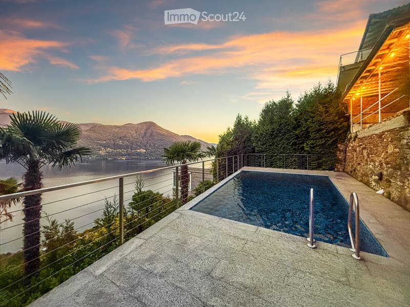 small rectangular pool, metallic railing, view of mountain and lake