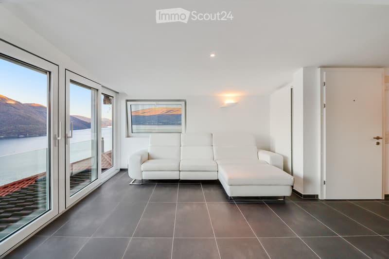 white modern leather couch, large windows, tile flooring