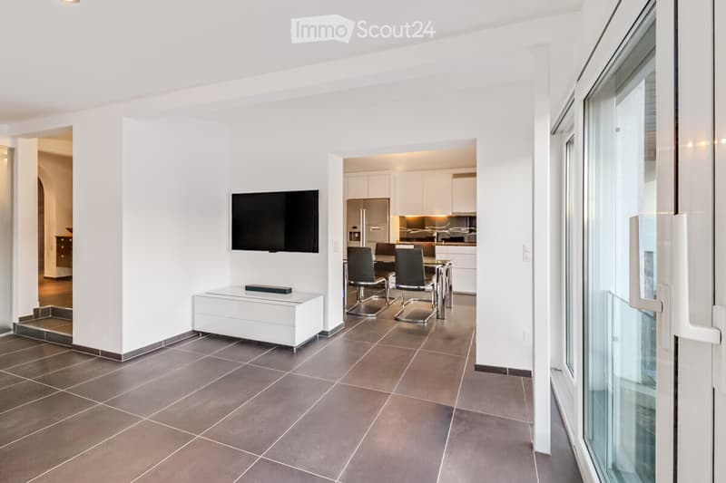 modern design, white walls, large flat screen TV, dining table, modern kitchen