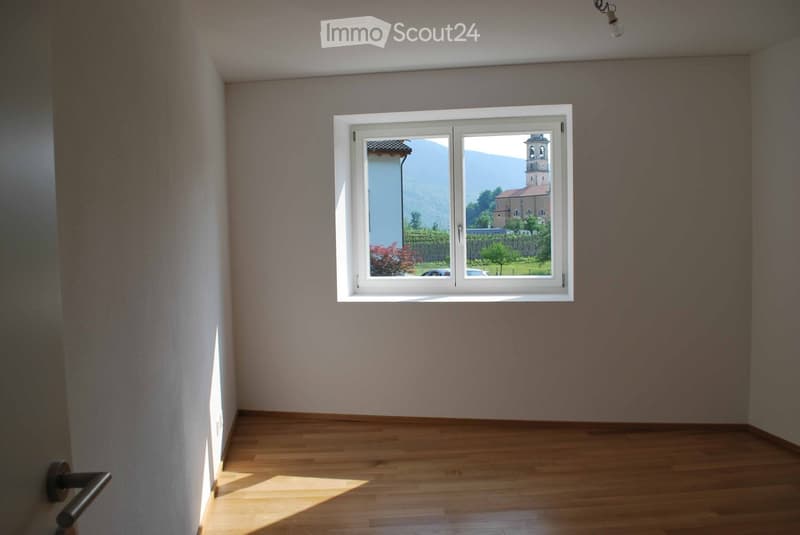 empty room, window with view of church and mountains, wooden floor
