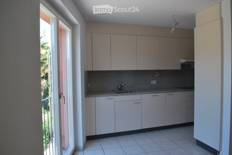 modern, white cabinets, grey countertops, sink, window with glass doors to terrace