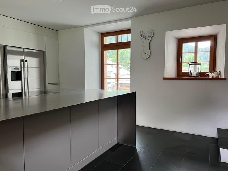 open kitchen, island, stainless steel appliances, wooden windows, tiled floor