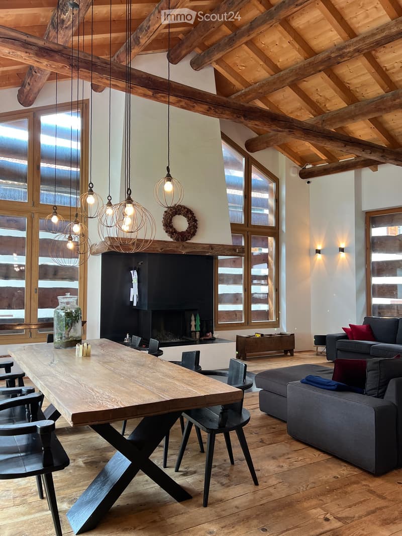 wooden table, wooden floor, fireplace, wooden beams, pendant lights