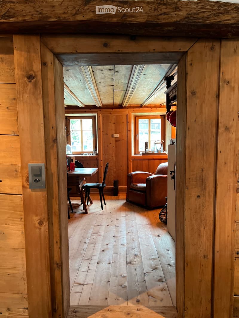 wooden walls and floors, living room furniture, open door