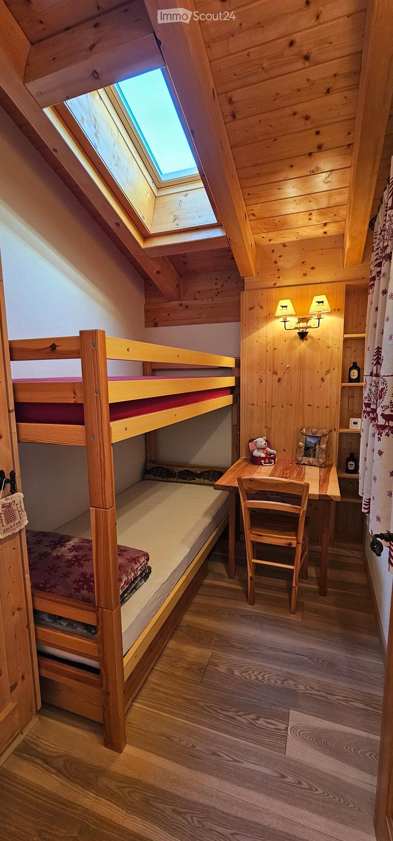 wooden bunk bed, wooden desk, chair, skylight, wooden wall paneling