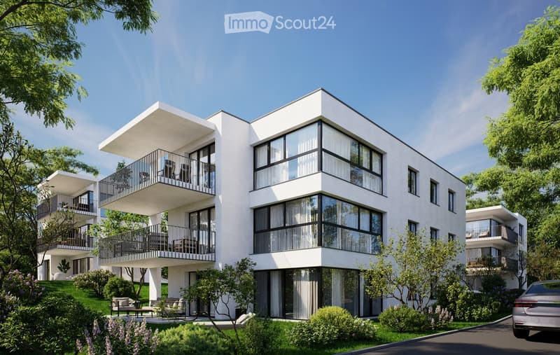 3 story apartment building, white exterior, large windows, multiple balconies, well-kept garden, driveway