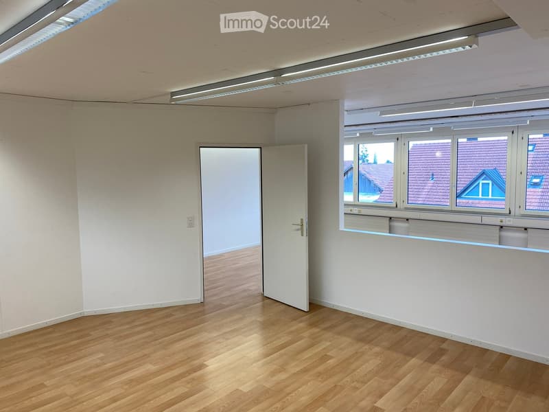wooden floor, white walls, open door, large windows, two doors