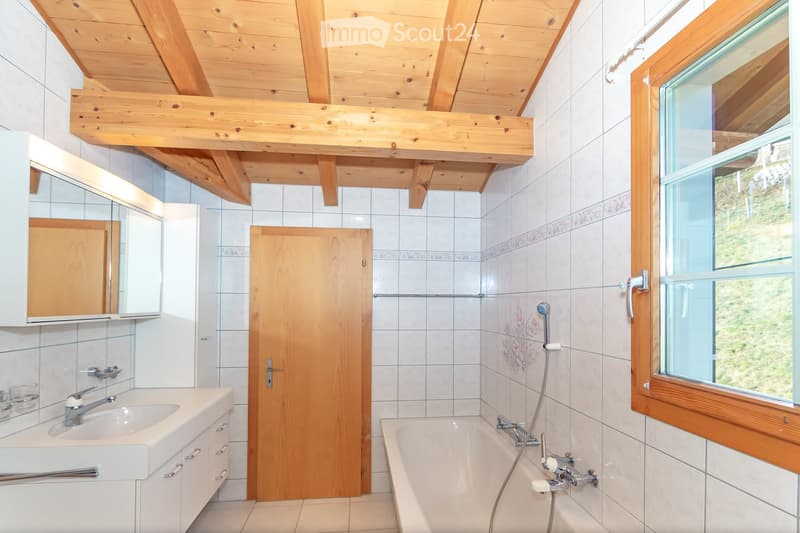 wooden ceiling, white tiles, bathtub with shower, sink, mirror, door