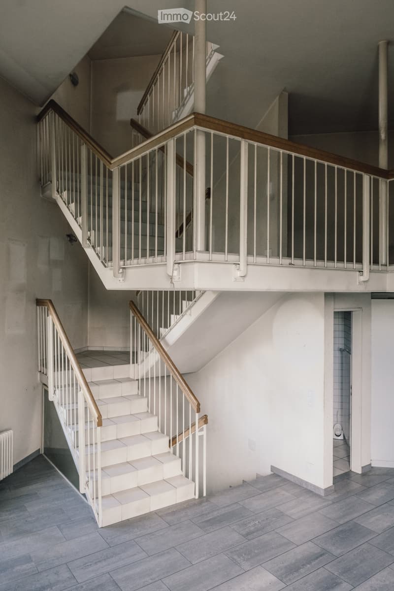 two-level staircase, white tiles, white walls, gray flooring