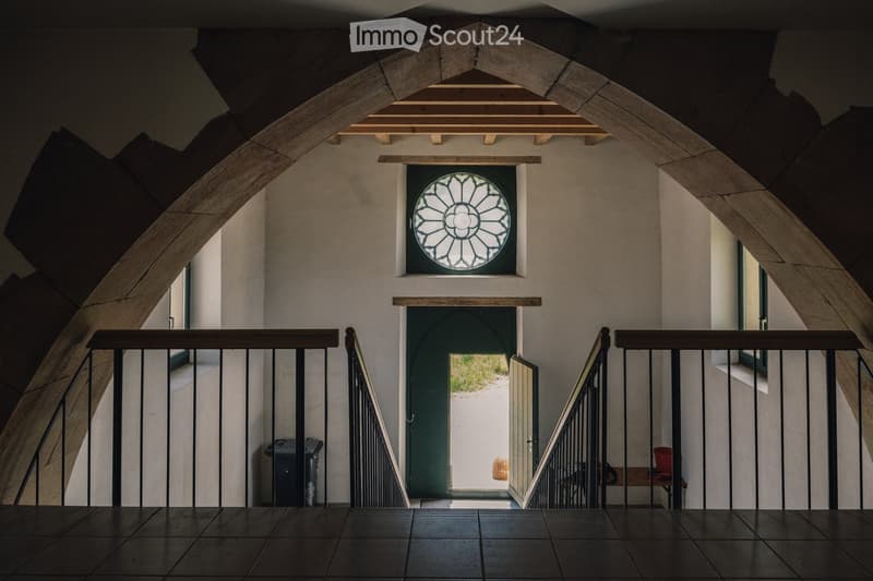 Arched entrance, wooden ceiling, arched window, open door, tiled floor