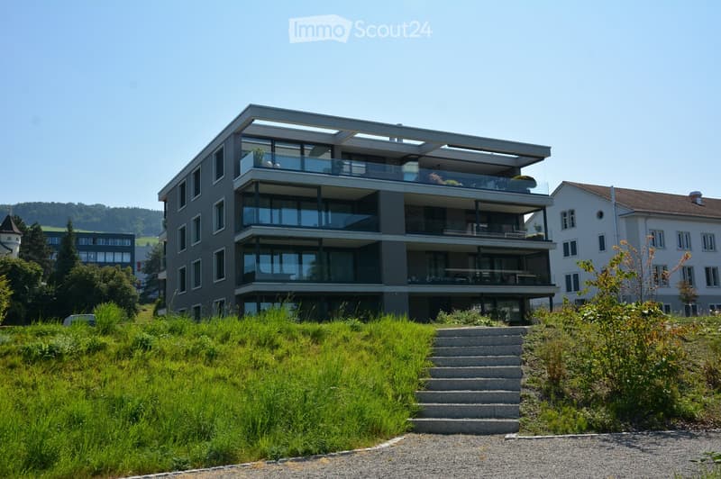 residential apartment building, several balconies, modern architecture, concrete exterior