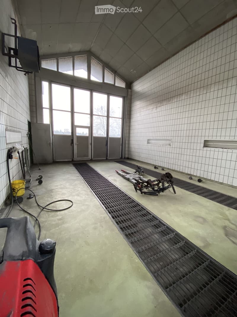 industrial-style room, white tiled walls, metal grates, metal framework, bicycle parts