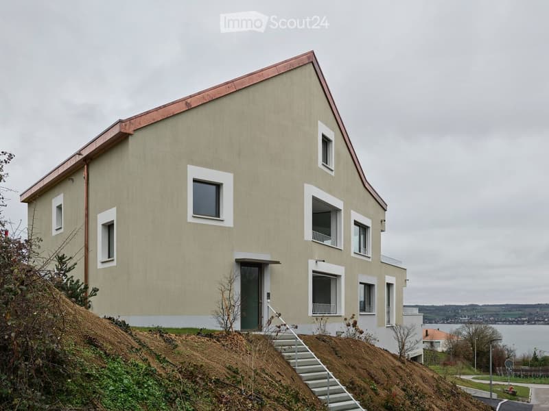 2 story house, copper roof, large windows, located on hill, view of sea