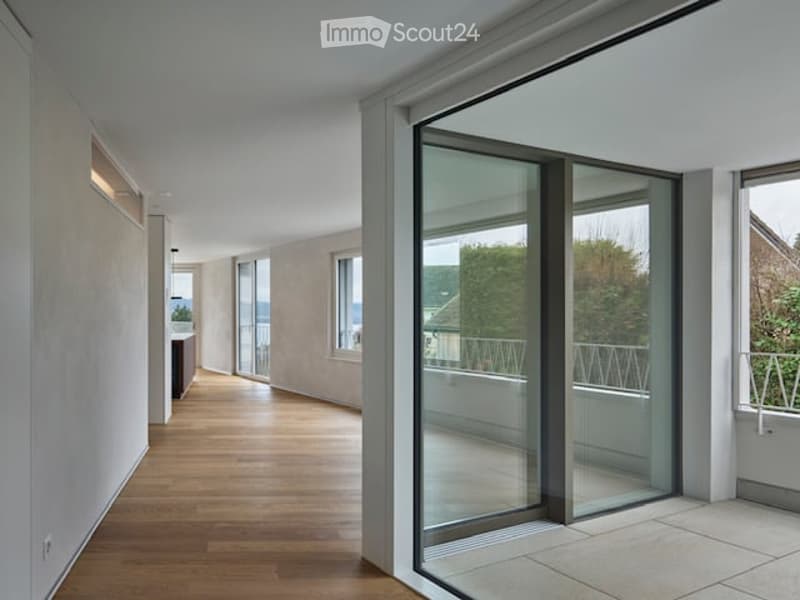 wooden floor, white walls, large glass doors, balcony
