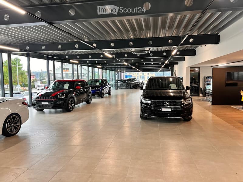 modern showroom with multiple cars, white and beige floor, glass walls and doors, metal beams