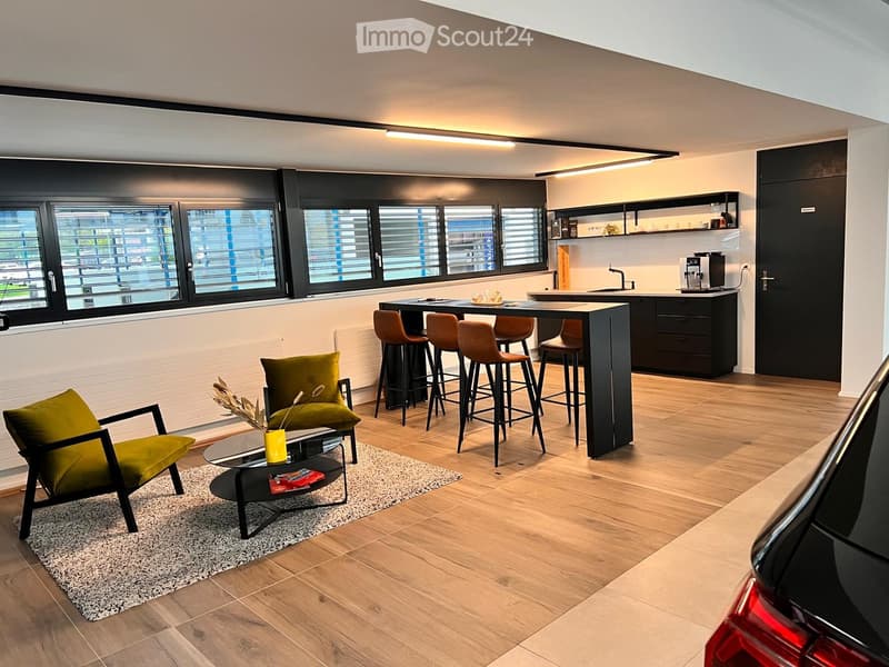 open plan living room and kitchen, dining area, wooden floor, central island, wooden counter stools, modern green armchairs, coffee table, radiators, large windows with shutters, modern cabinets, kitchen appliances