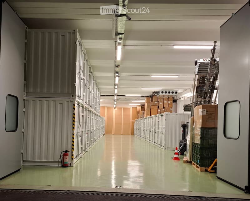 Storage facility with metal storage boxes, fire extinguisher, boxes, ladder, and a forklift