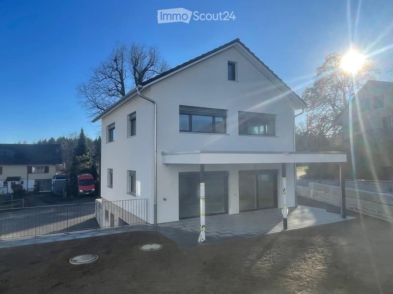 Two story house, white exterior, large windows, garage, parking area, driveway, metal fence