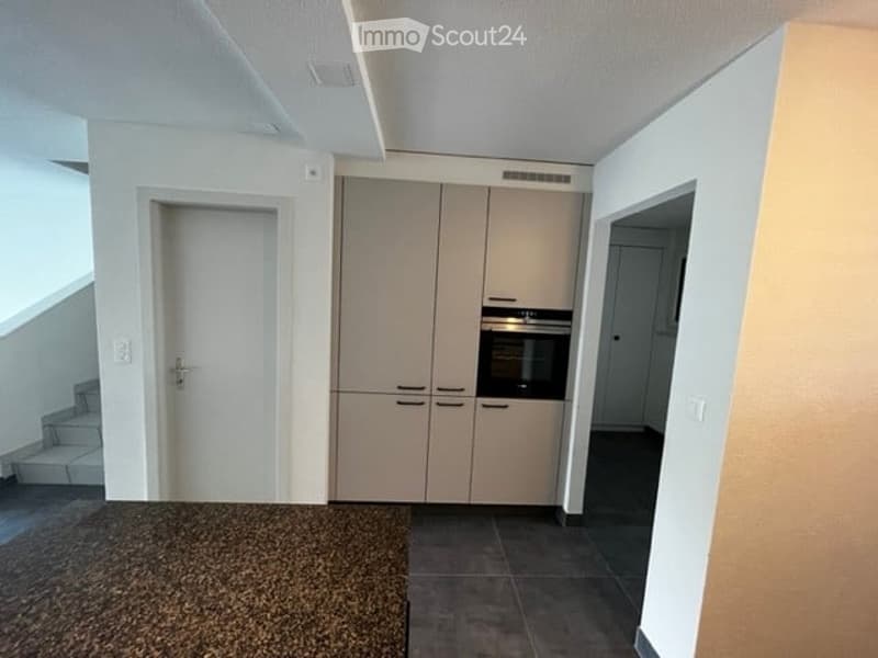 empty room with a built-in oven and cupboards
