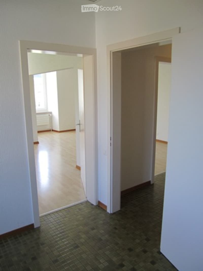 Two doors, wooden floor, empty room